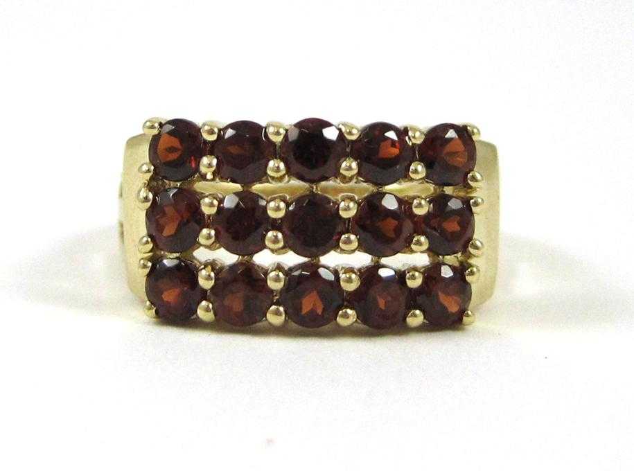 Appraisal: HESSONITE GARNET AND FOURTEEN KARAT GOLD RING set with round-cut