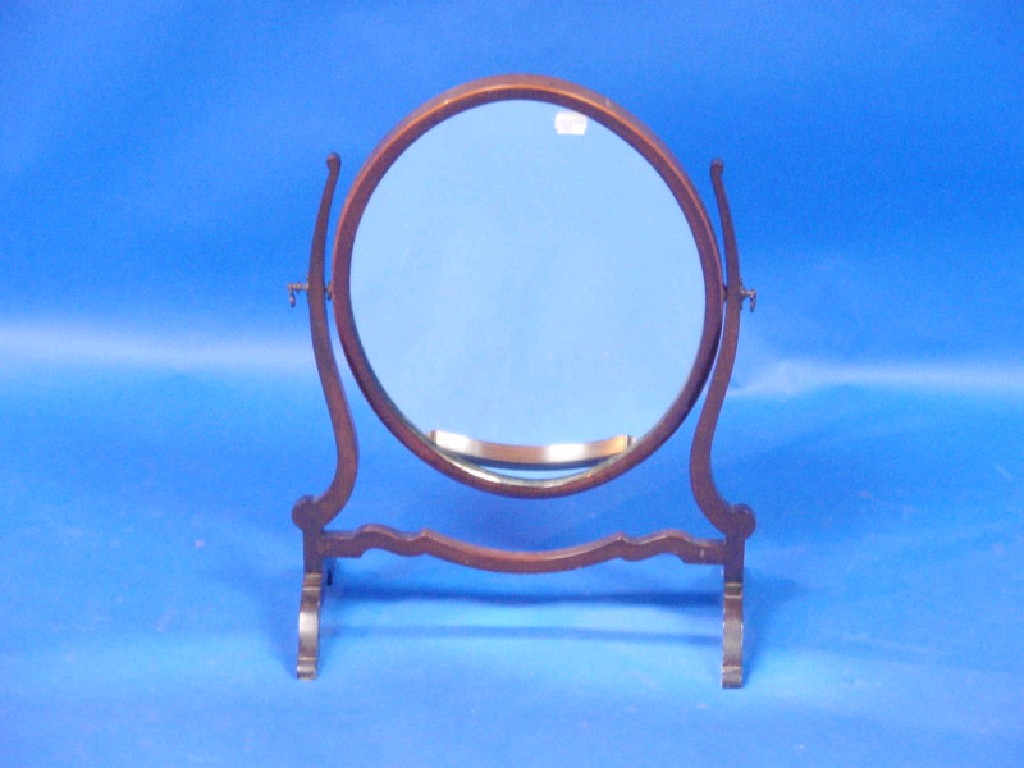 Appraisal: A Georgian style oval mahogany framed toilet mirror on scroll