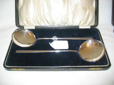 Appraisal: A PAIR OF SERVING SPOONS the flat tapering hafts with