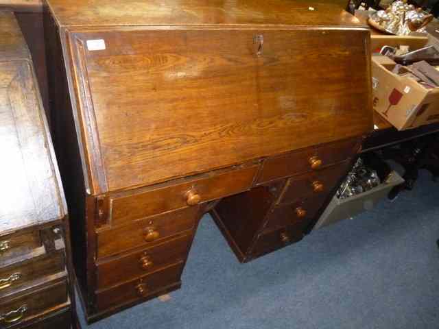 Appraisal: AN OAK BUREAU the fall front over two short drawers