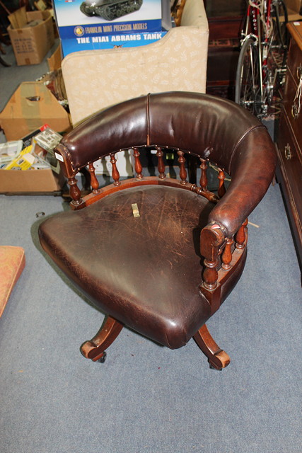 Appraisal: A MAHOGANY BROWN LEATHER UPHOLSTERED DESK CHAIR the horseshoe back