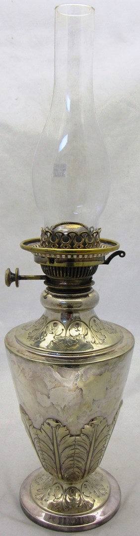 Appraisal: A silver plated oil lamp the tapering body decorated with