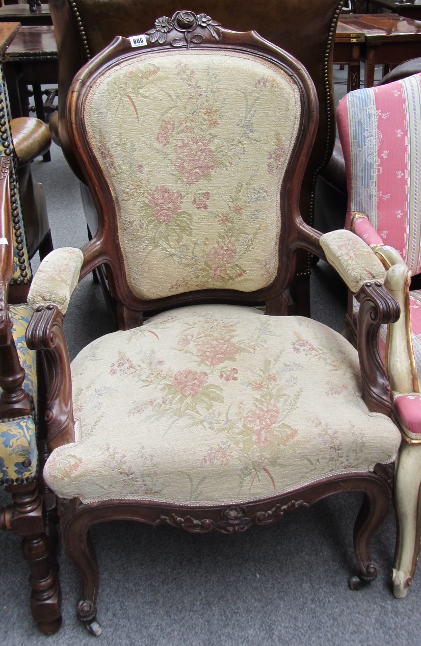 Appraisal: A Victorian mahogany framed spoonback armchair with semi padded arms