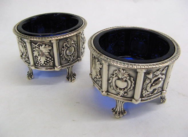 Appraisal: PAIR AMERICAN STERLING SILVER SALT CELLARS c repousse panels of