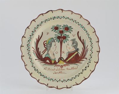 Appraisal: A Dutch decorated creamware plate with feathered rim painted with