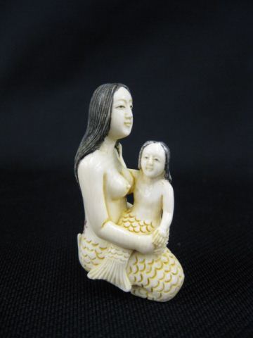 Appraisal: Carved Ivory Netsuke of Seated Mermaidholdup a mermaid child on