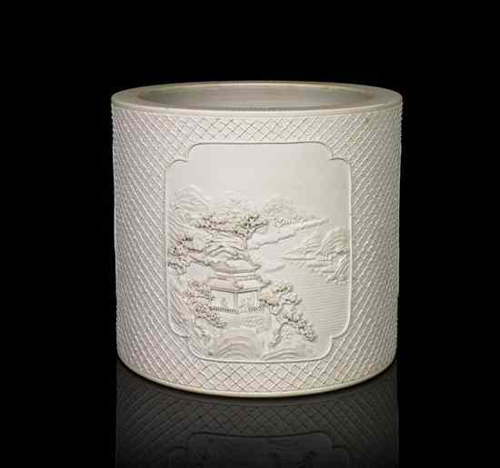 Appraisal: A White Carved and Molded Unglazed Biscuit Porcelain Brushpot containing