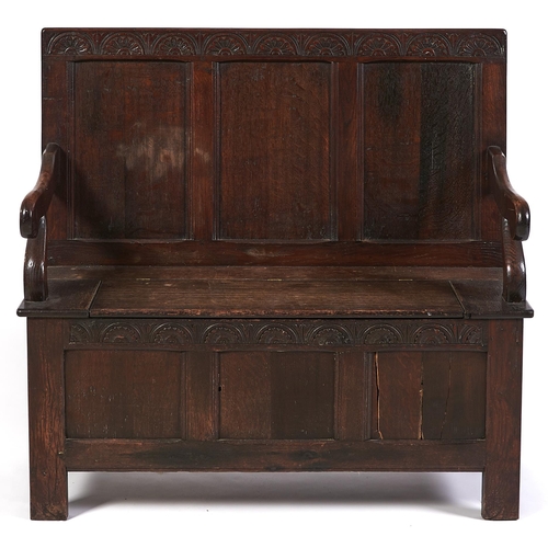 Appraisal: An oak settle the three panel back with lunette carved