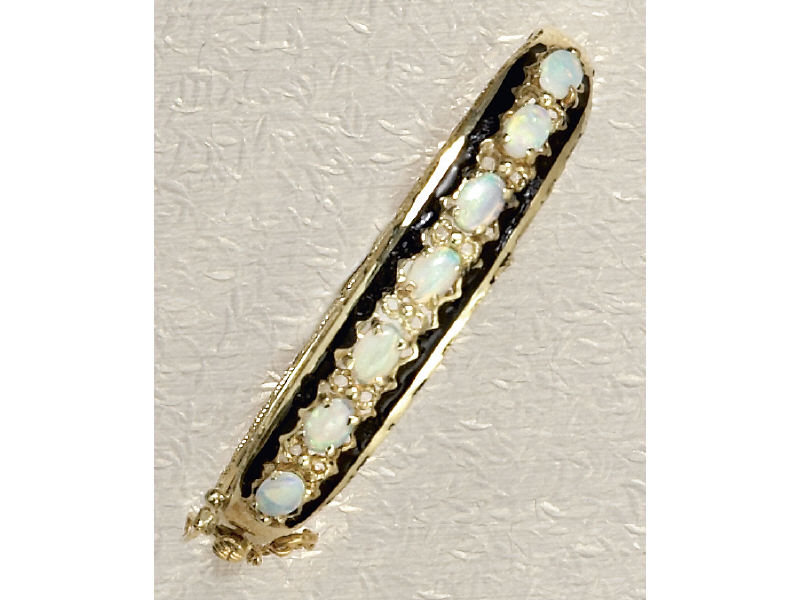 Appraisal: OPAL BANGLE BRACELET Yellow gold bangle set with seven oval