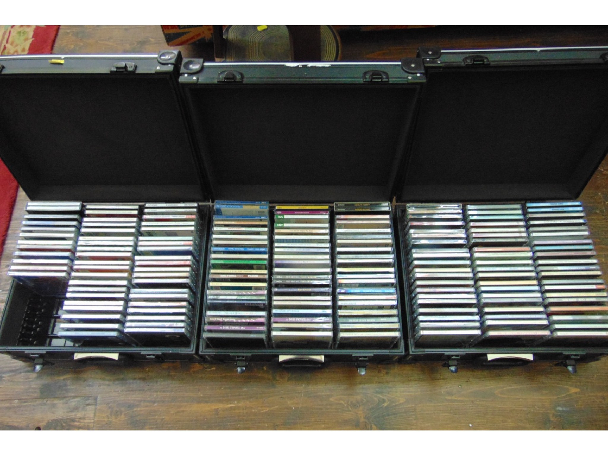 Appraisal: Three black carrying cases containing a quantity of assorted CDs