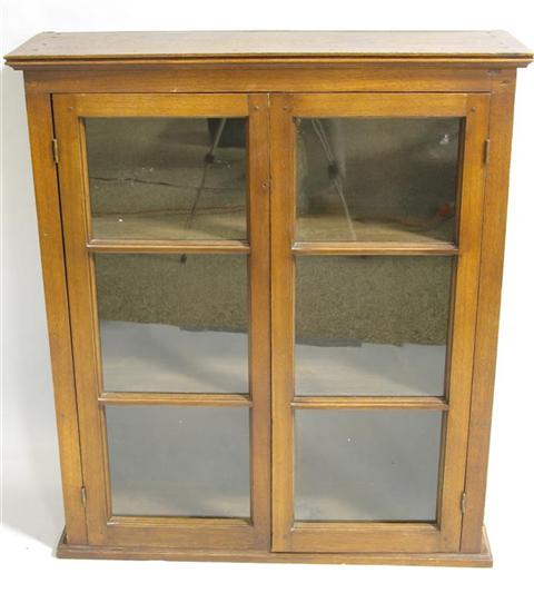 Appraisal: ENGLISH MAHOGANY GLASS FRONT HANGING CABINET The molded cornice over