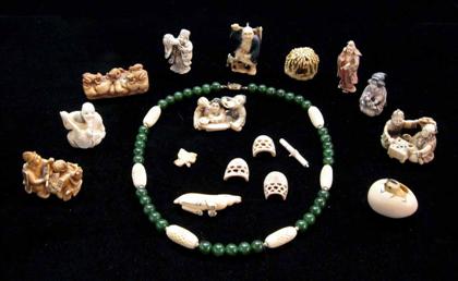 Appraisal: Group of twelve ivory bone and composition carved netsukes and