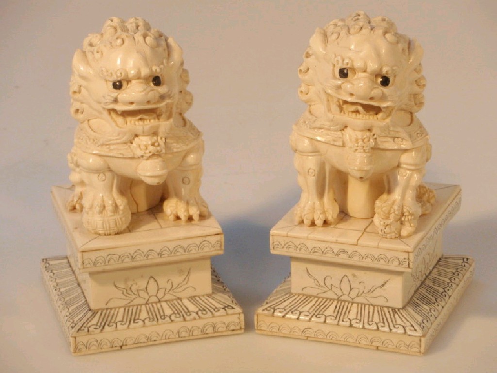 Appraisal: A pair of Chinese ivory carved figure of lion dogs