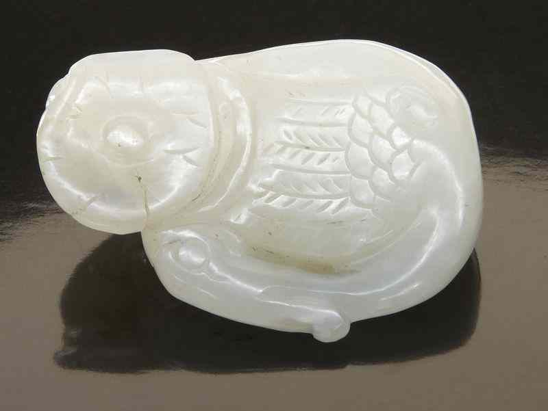 Appraisal: Chinese Qing carved white jade duck seated on a lotus