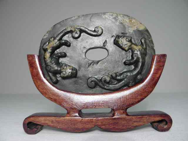 Appraisal: Early Chinese carved jade bi disc Carved with a dragon