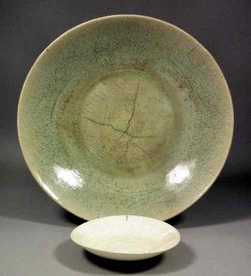 Appraisal: An Oriental porcelain celadon glazed dish decorated in sgraffito with