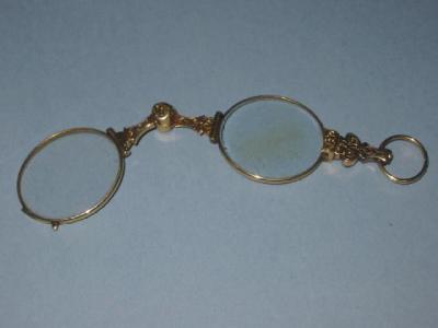 Appraisal: A PAIR OF VICTORIAN GOLD LORGNETTES with chased flowers wide