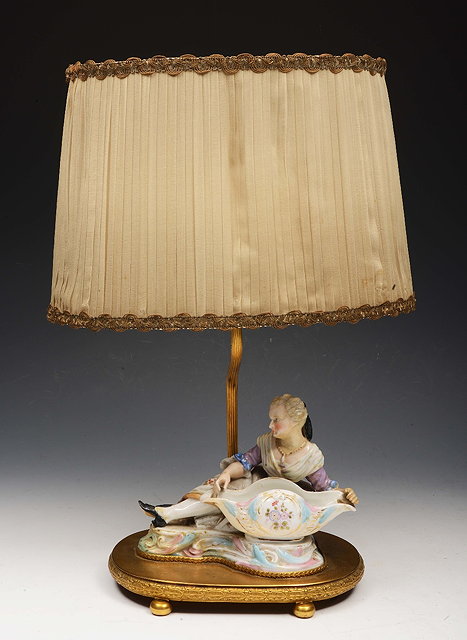 Appraisal: A PORCELAIN TABLE LAMP in the form of a reclining