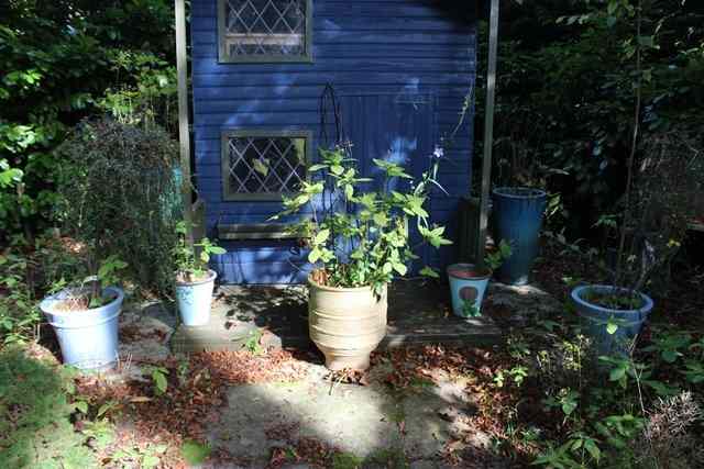 Appraisal: A TERRACOTTA PLANTER with three loop handles together with six