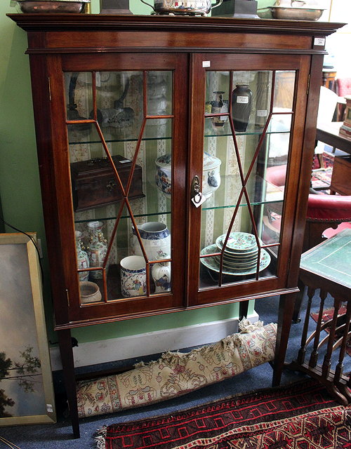 Appraisal: A MAHOGANY DISPLAY CABINET the interior fitted with two glass