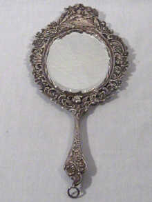 Appraisal: A Dutch silver hand mirror with ornate frame circa