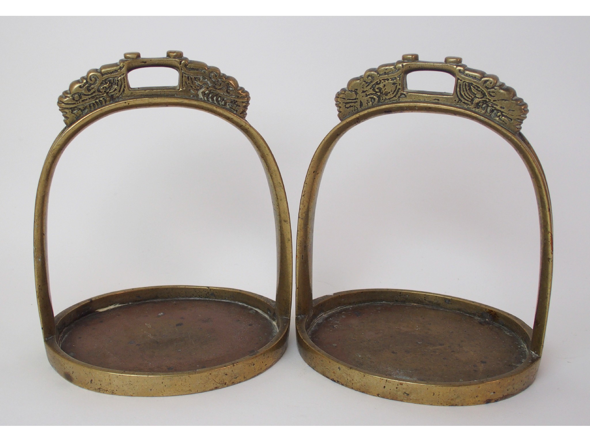 Appraisal: A pair of Chinese brass horse stirrupscast with grotesques cm