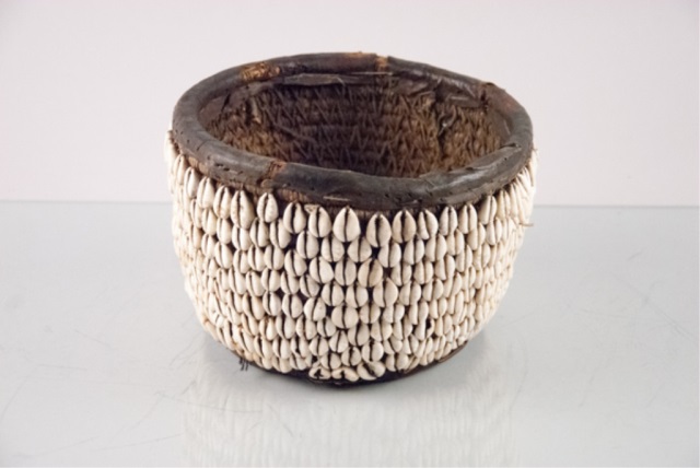 Appraisal: African Basket Handmade by natives Cowie shells stitched on leather