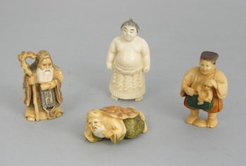 Appraisal: A Group of Carved Ivory Netsuke Containing a standing bearded