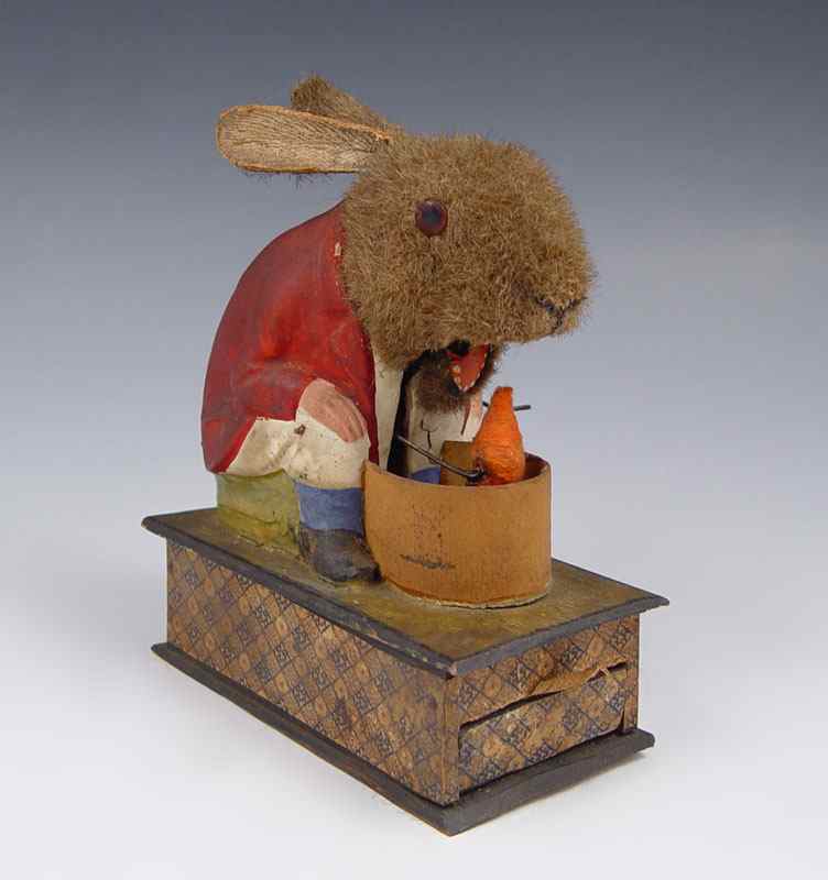 Appraisal: BUNNY EATING THE REVOLVING CARROT VINTAGE TOY Mohair rabbit with