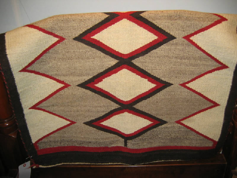 Appraisal: NAVAJO SADDLE BLANKET The natural tan field shows central row