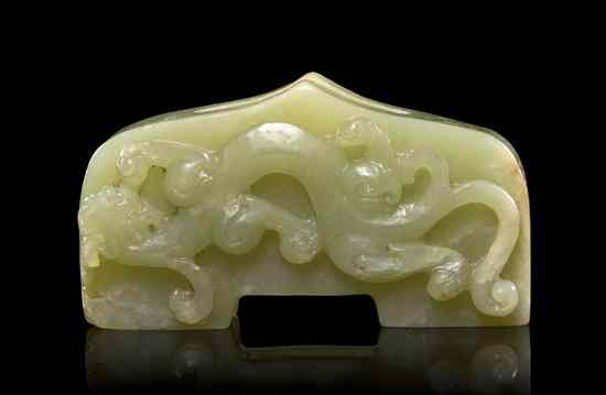 Appraisal: A Carved Jade Sword Hilt of yellow and opaque brown