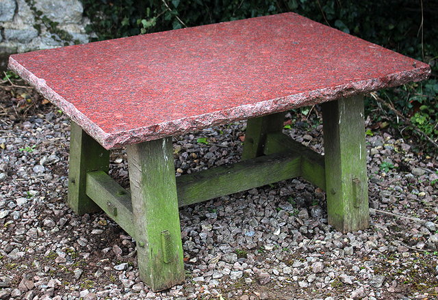 Appraisal: A RECTANGULAR LOW GARDEN TABLE with red granite top the