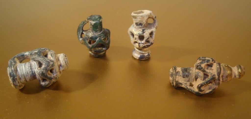 Appraisal: Four small late Roman blue glass juglet pendants with openwork