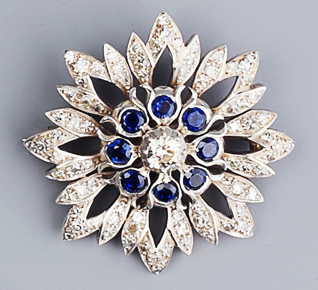 Appraisal: A DIAMOND AND GEM SET SNOWFLAKE BROOCH the pierced stylized