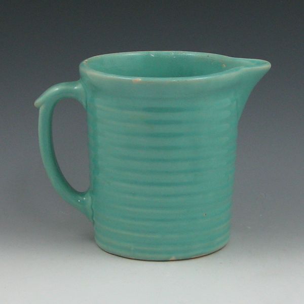 Appraisal: Weller Kitchengem pitcher in turquoise Marked with Weller Pottery kiln