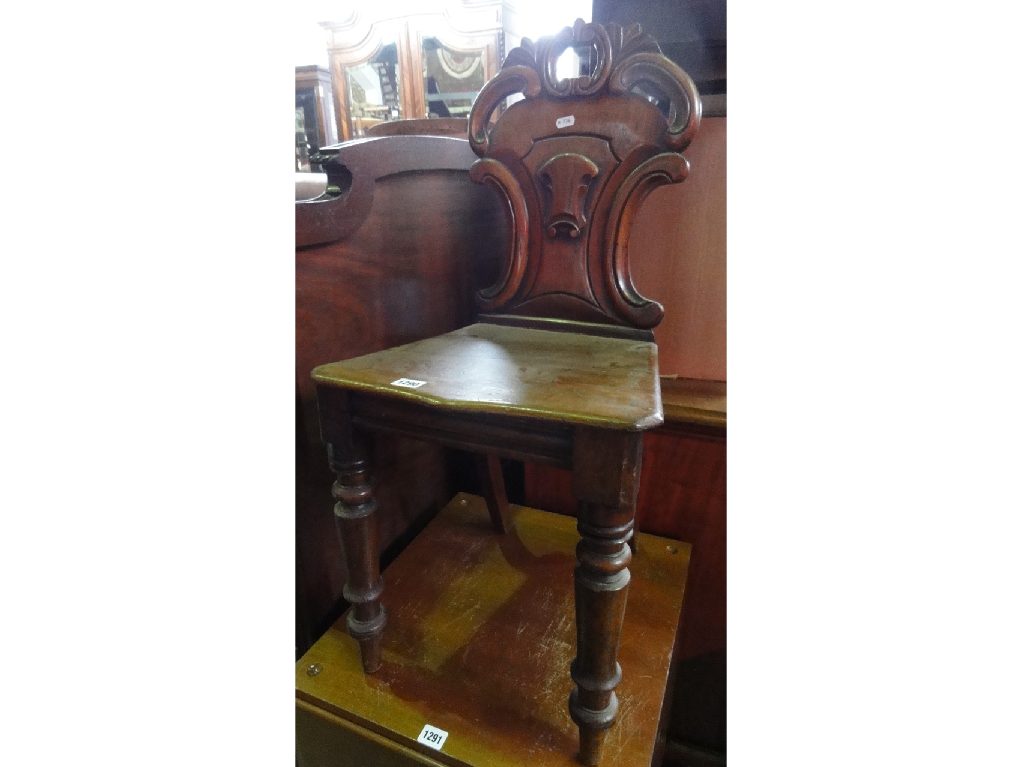 Appraisal: A Victorian mahogany hall chair the shield shaped back with