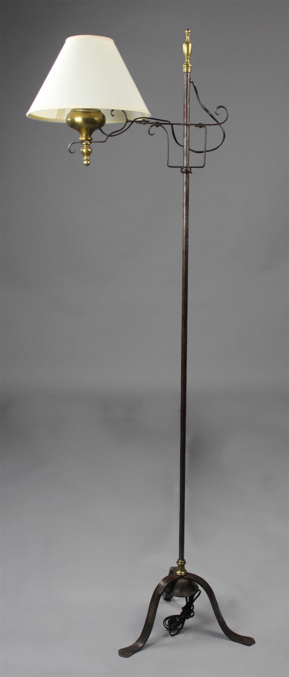 Appraisal: COLONIAL STYLE BRASS AND METAL FLOOR LAMP with adjustable foot