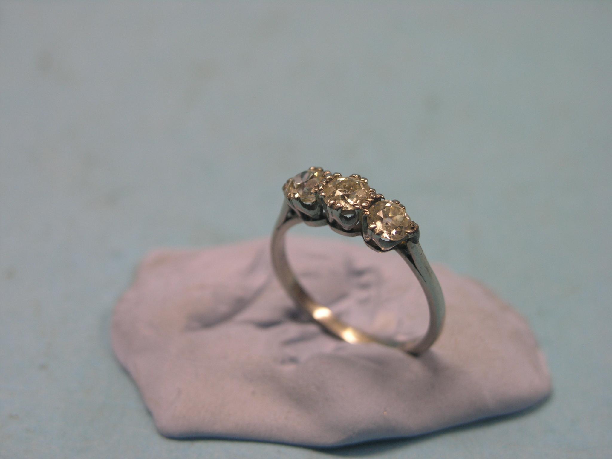 Appraisal: A diamond three-stone half-hoop ring each stone approx ct unmarked