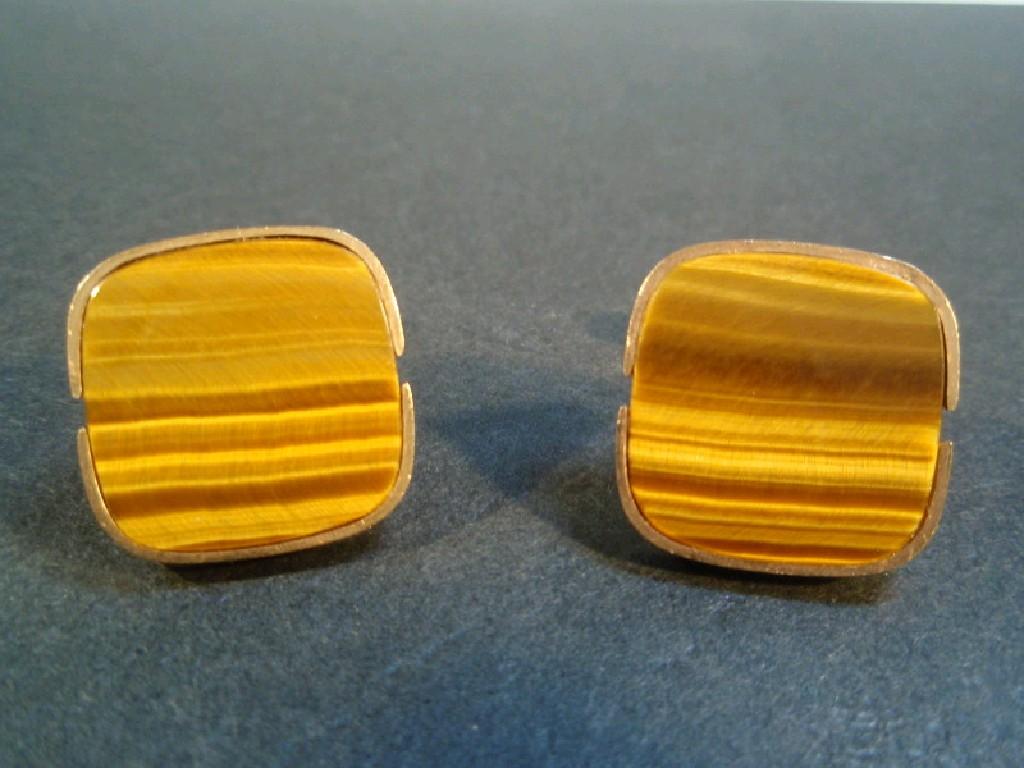 Appraisal: A pair of cuff links set with tigers eye agate