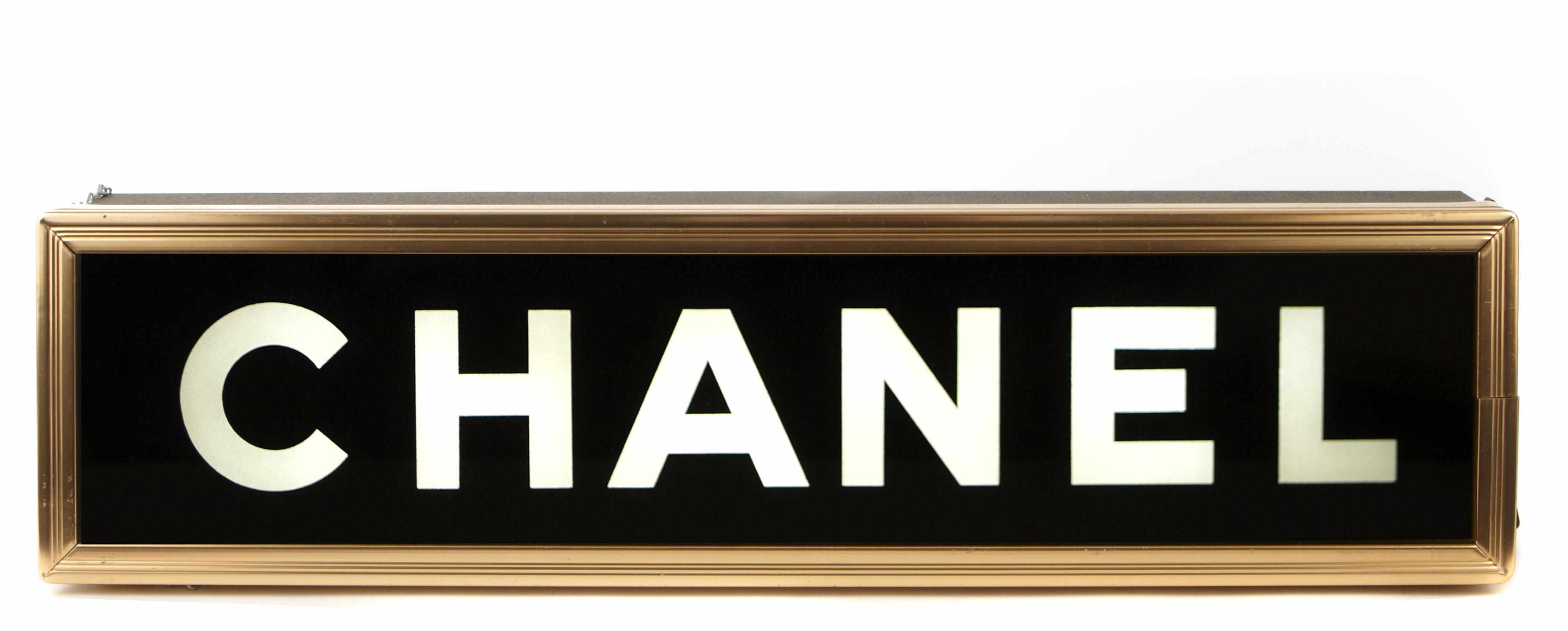 Appraisal: A reverse painted glass and brass illuminated Chanel boutique sign