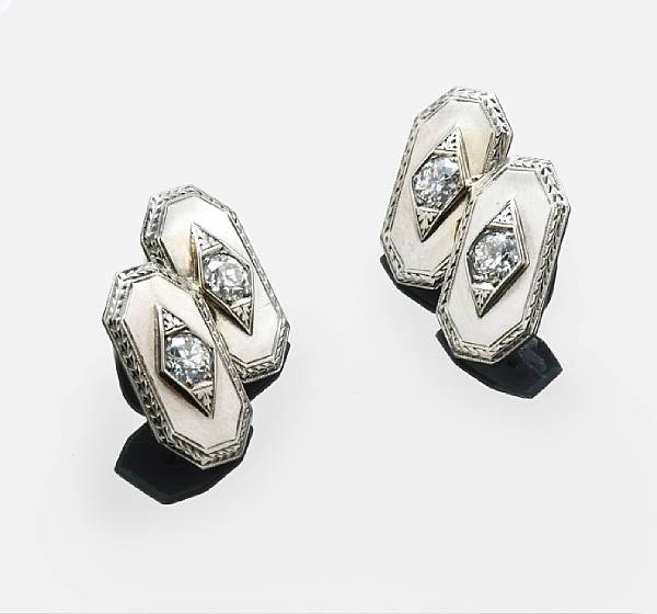 Appraisal: A pair of diamond and fourteen karat white gold earclips