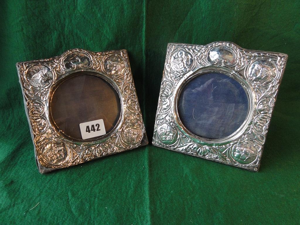 Appraisal: A pair of silver photograph frames with cherub and scrolled