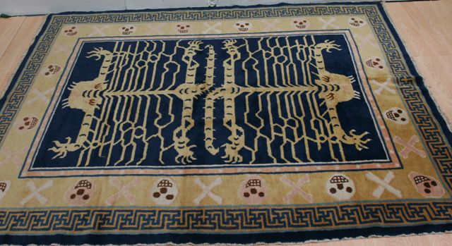 Appraisal: A Tibetan yellow and blue ground tiger rug with key