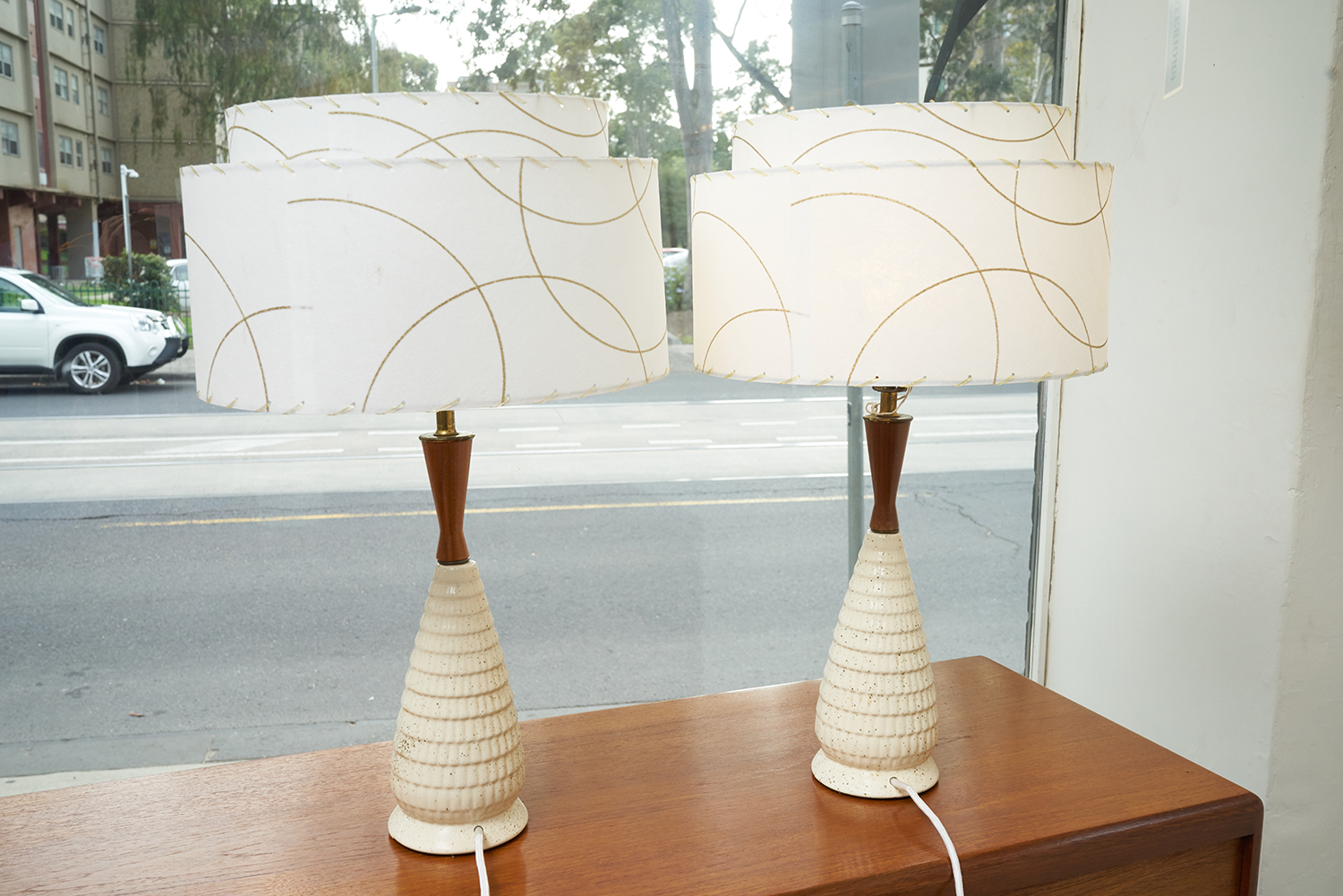 Appraisal: A PAIR OF s CERAMIC AND TEAK LAMPS Decorative parchmant