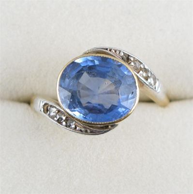 Appraisal: A sapphire and diamond ring The oval shaped sapphire is