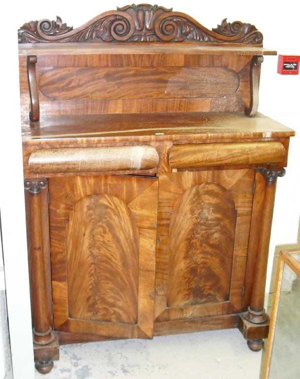 Appraisal: Victorian mahogany chiffonier with a raised scroll carved back over