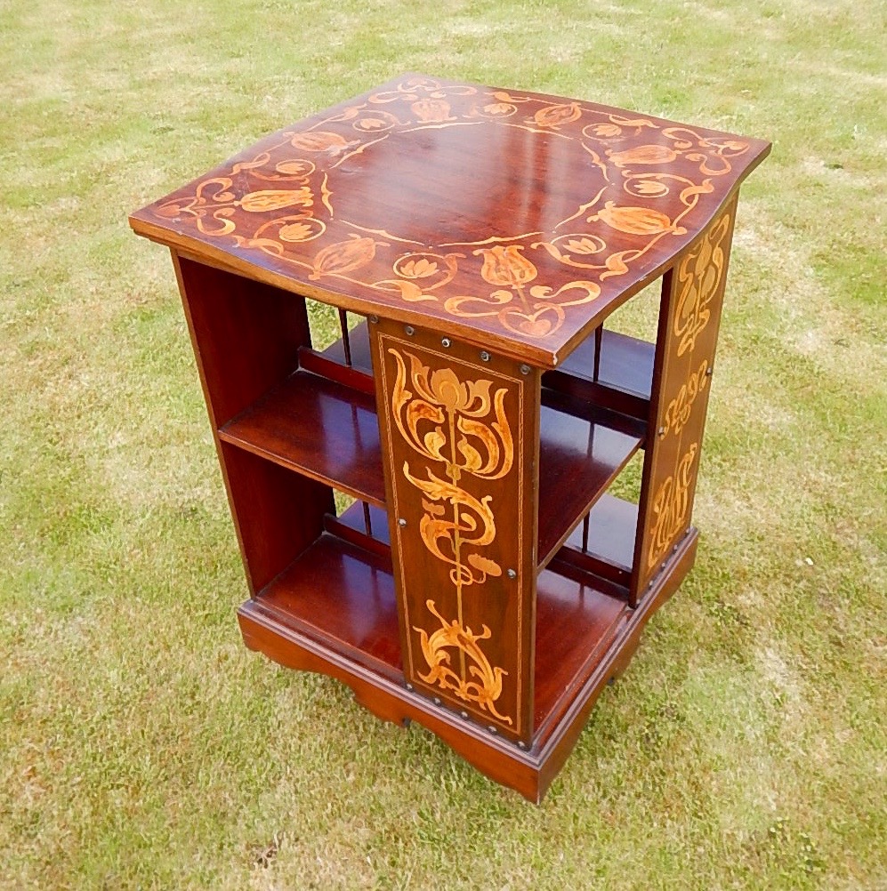 Appraisal: An Art Nouveau mahogany and marquetry revolving book stand by