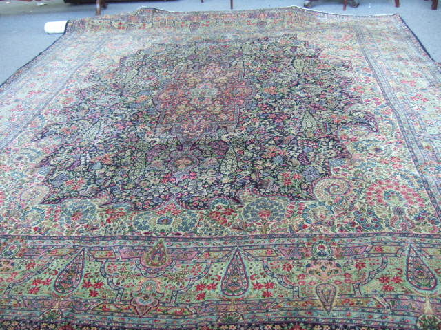 Appraisal: A Kerman carpet Persian the dark indigo field with central