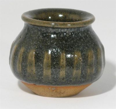 Appraisal: A Katharine Pleydell-Bouverie stoneware cut-sided vase covered in a green