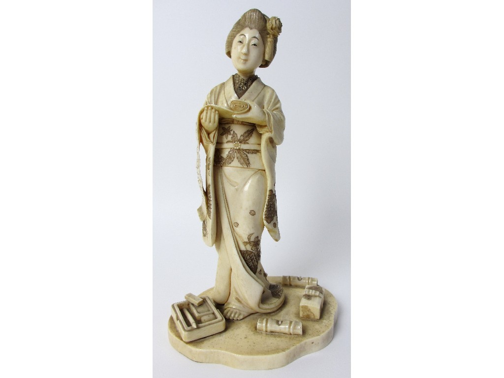 Appraisal: A Japanese carved ivory figure of a scholar the lady